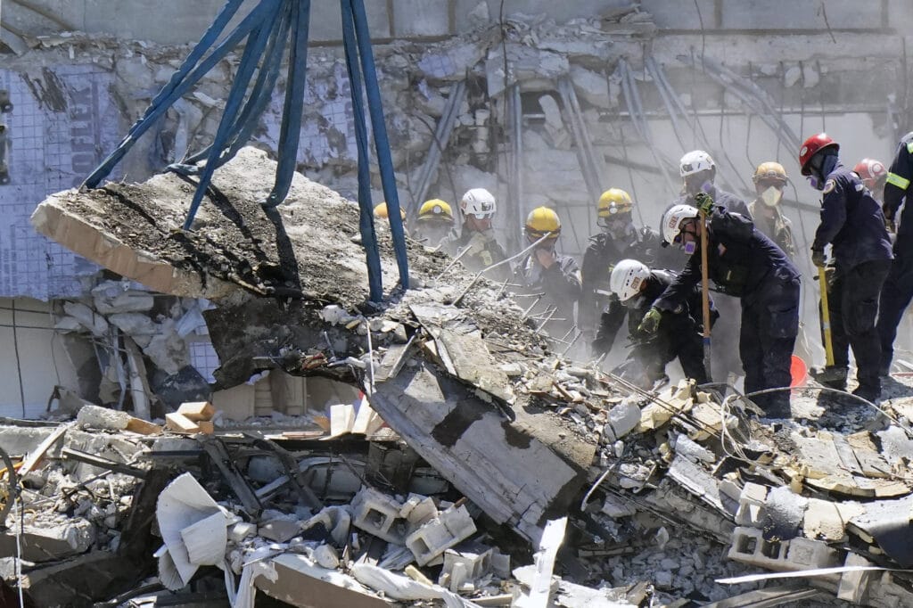 Rescue workers digging feverishly for a fifth day Monday