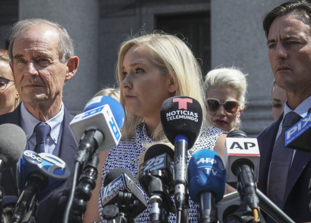 Virginia Giuffre, center, who says she was trafficked by sex offender Jeffrey Epstein,