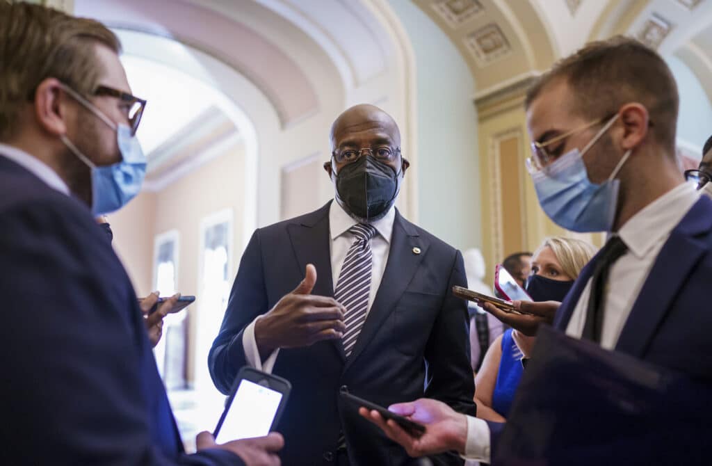 Sen. Raphael Warnock, D-Ga., a key figure on voting rights efforts, speaks to reporters