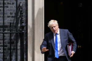 UK's Johnson battles to stay in job after top ministers quit