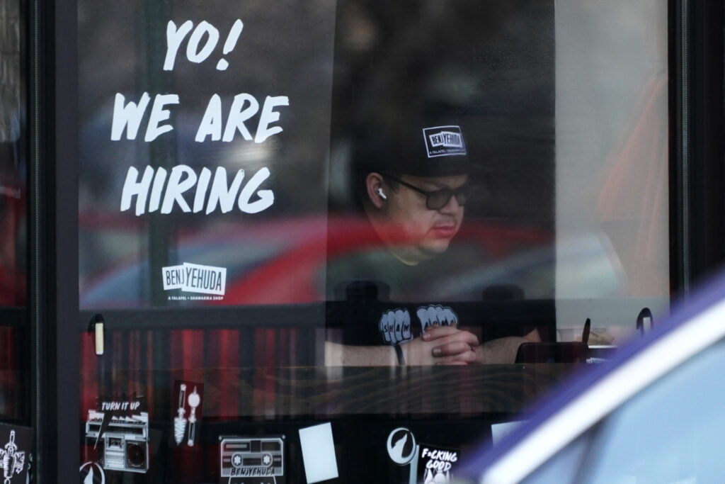 Jobless claims edge lower, Fed seeks to cool labor market