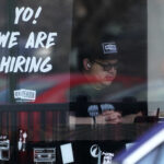 Jobless claims edge lower, Fed seeks to cool labor market