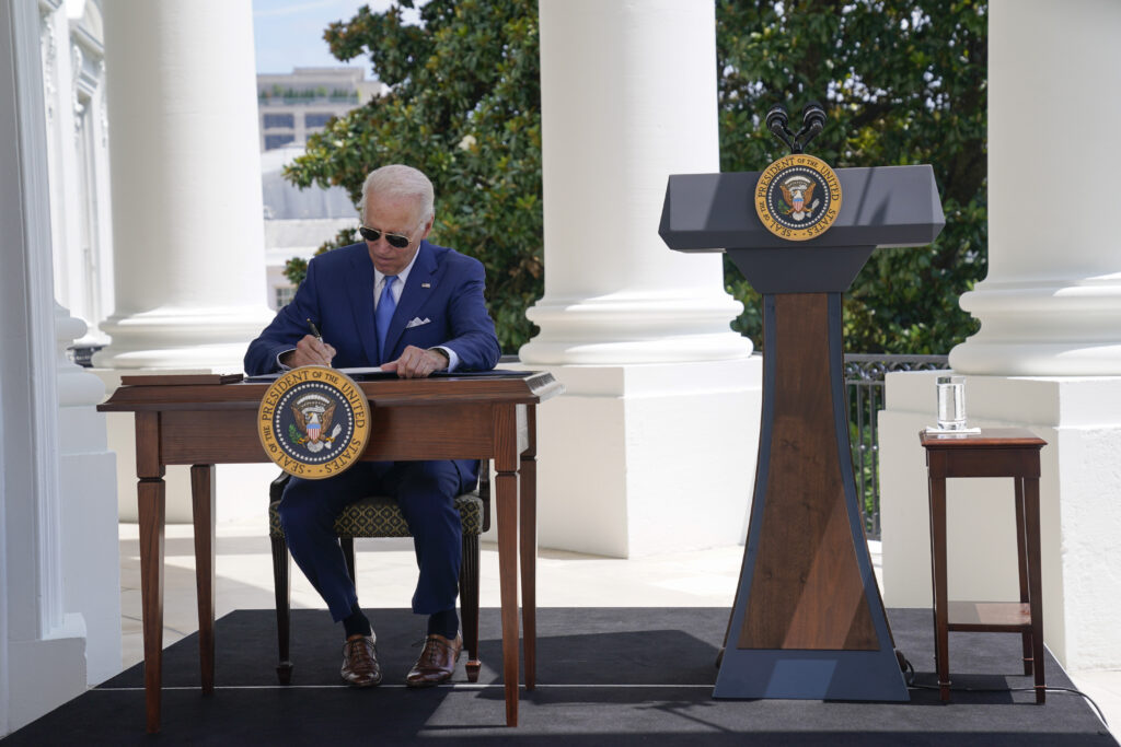 Still isolating, Biden signs anti-fraud pandemic bills